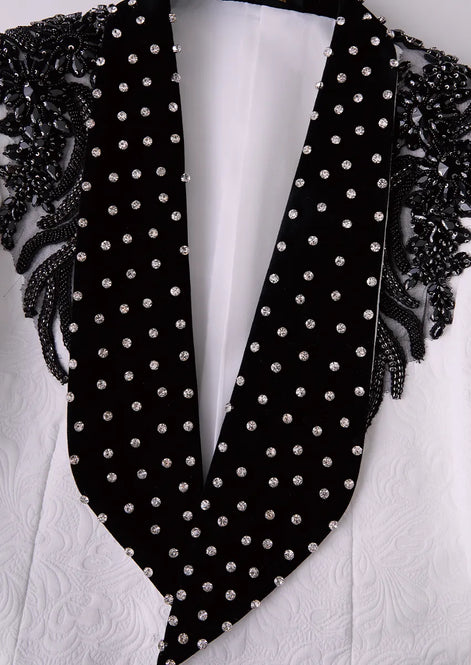 Close up of black velvet shawl collar with heavy black crystal wing embroidery