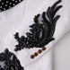 White jacquard sleeve with black beaded wing embroidery cuff detail