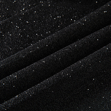  Detail view of black micro-glitter fabric texture and velvet covered buttons 