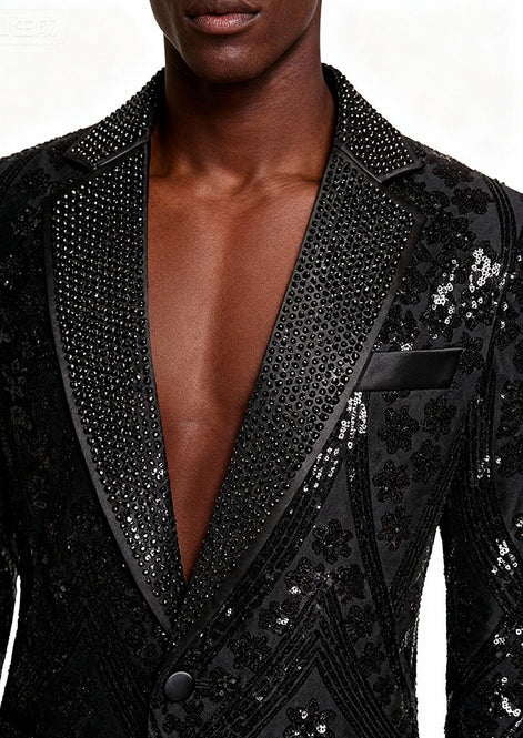 Close up of black micro-beaded detail on notched lapel of velvet jacket