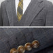Close up of notched lapel and gold-accented windowpane fabric texture