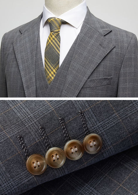 Close up of notched lapel and gold-accented windowpane fabric texture
