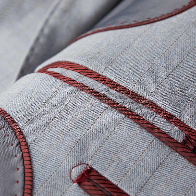 Detail view of bespoke ruby-red interior piping and lining on Nevo light grey suit