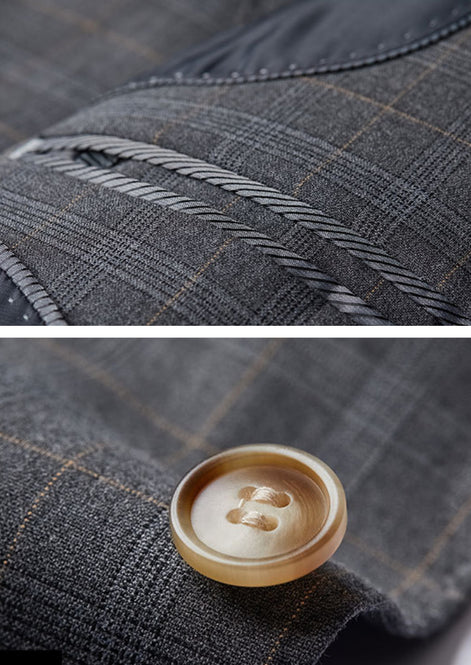 Detail view of horn-patterned buttons and cross-stitching on grey plaid sleeve