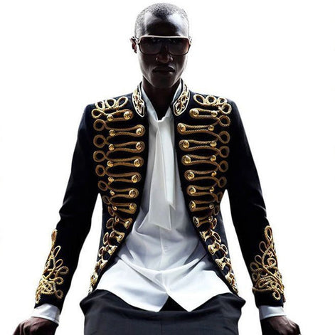 Black male model wearing The Royal Commander velvet military tuxedo with gold braiding - Nevo Suits