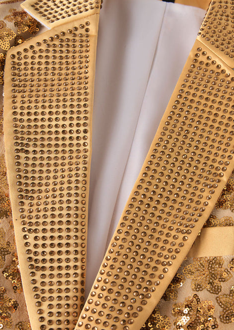 Close up of gold crystals on notched lapel of gold dinner jacket