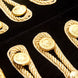Detail of gold rope frogging and metal buttons on black velvet jacket