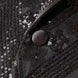 Close up of black fabric-covered buttons on sequined velvet sleeve