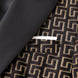 Model wearing Obsidian Eclipse black and gold greek-key jacquard tuxedo with satin peak lapels - Nevo Suits
