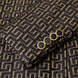 Model wearing Obsidian Eclipse black and gold greek-key jacquard tuxedo with satin peak lapels - Nevo Suits