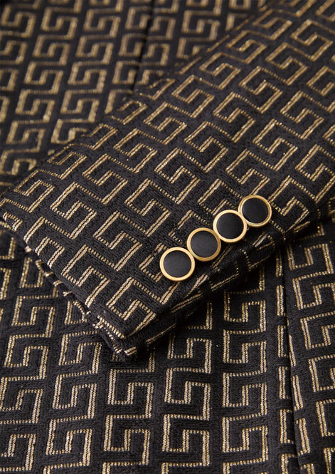 Model wearing Obsidian Eclipse black and gold greek-key jacquard tuxedo with satin peak lapels - Nevo Suits