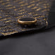 Model wearing Obsidian Eclipse black and gold greek-key jacquard tuxedo with satin peak lapels - Nevo Suits