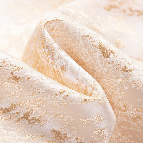 Detail view of champagne gold shimmering jacquard fabric texture |