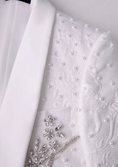 Close up of white satin shawl collar with scattered pearls and silver crystal details