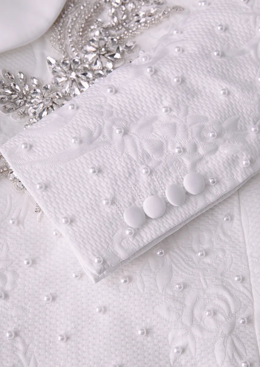 Close up of white fabric covered buttons on pearl embellished tuxedo jacket - Pearl Symphony - Nevo Suit™