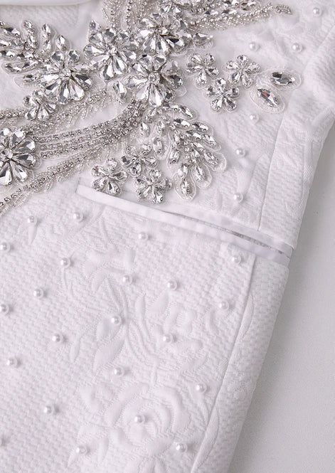Detail of heavy silver crystal applique on white tuxedo jacket