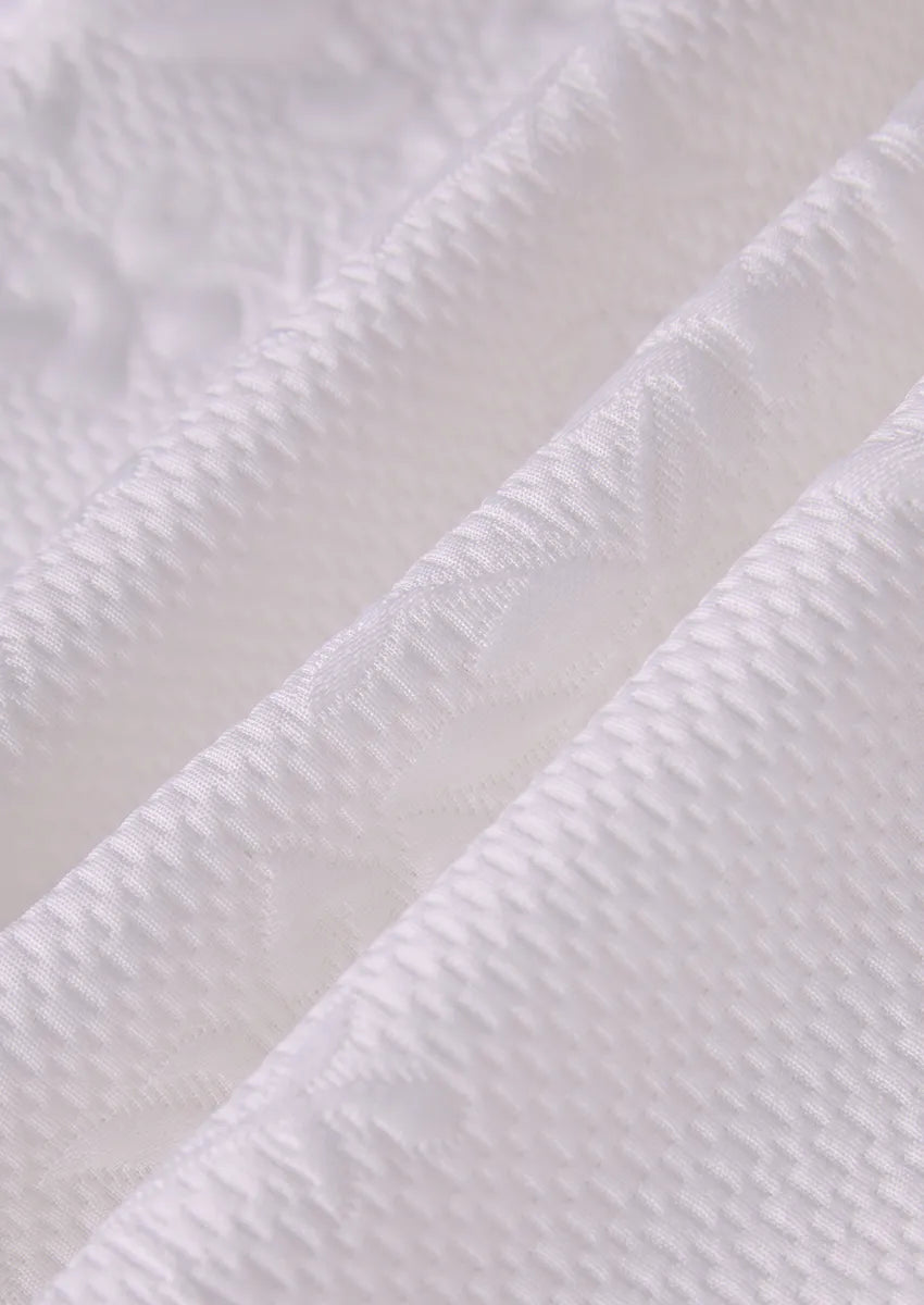 Close up of white 3D textured jacquard fabric and hand-applied pearl detailing - Pearl Symphony - Nevo Suit™