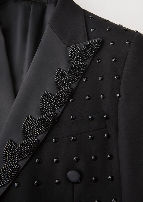 Close up of black sequin leaf vine embroidery and scattered crystals detail - Nevo Suits