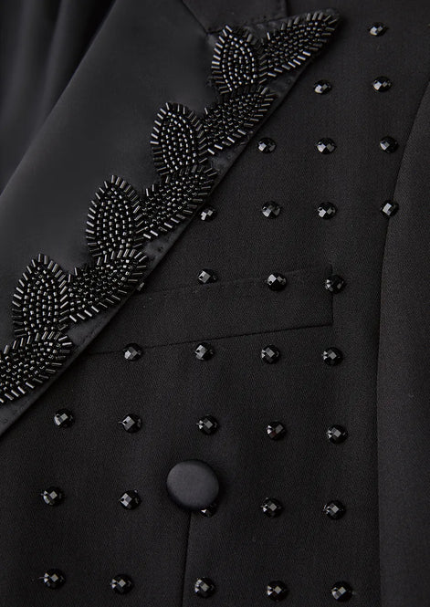 Close up of black sequin leaf vine embroidery and scattered crystals detail - Nevo Suits