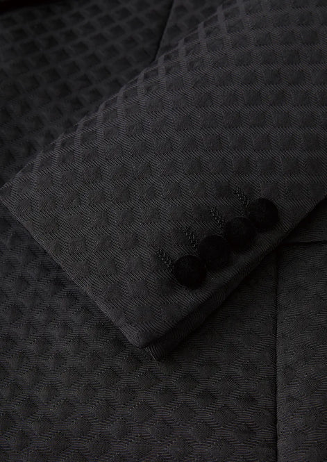 Close up of black velvet covered buttons on diamond jacquard sleeve