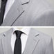Close up of notched lapel and herringbone fabric texture on grey suit jacket |