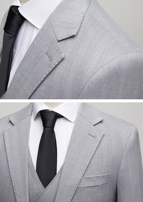 Close up of notched lapel and herringbone fabric texture on grey suit jacket |