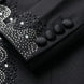 Close up of hand-placed onyx crystals and satin-covered buttons on tuxedo sleeve