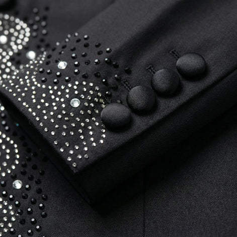 Close up of hand-placed onyx crystals and satin-covered buttons on tuxedo sleeve