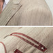 Close up of wide peak lapel and herringbone pinstripe fabric texture on khaki suit
