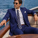 Ink Crownline royal blue 2-piece suit seated on a yacht