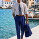 Ink Crownline royal blue trousers with matching jacket carried at a harbor