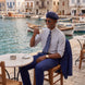 Ink Crownline royal blue suit trousers with matching jacket at a waterfront cafe