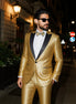 Man wearing a gold suit with black lapels on a city street at night.