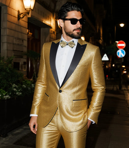 Man wearing a gold suit with black lapels on a city street at night.