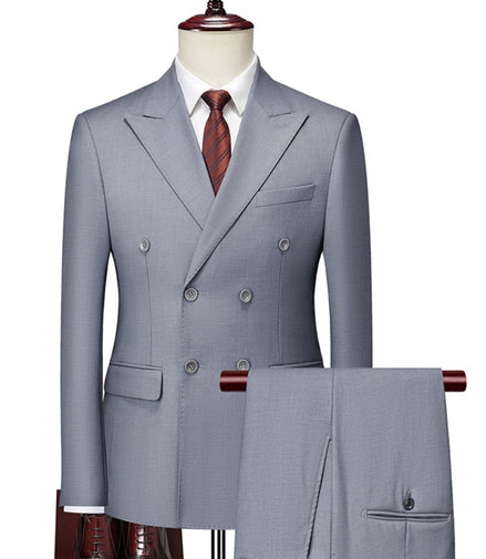 Gray double-breasted suit on a mannequin with a white shirt and red tie.