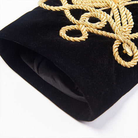 Gold braided cuff detail on black velvet military jacket