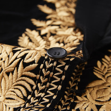 Black button detail on gold embroidered velvet tuxedo
