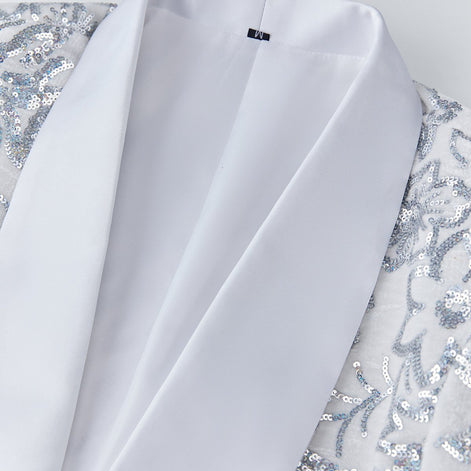 Close up of white satin shawl collar and silver sequin detail on velvet jacket