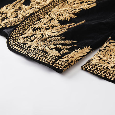 Gold embroidered hem detail on black velvet jacket

